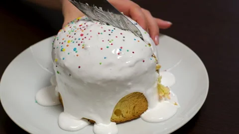 Traditional Easter cake with cut piece and colored eggs on light table. Candle Stock Footage 306765297