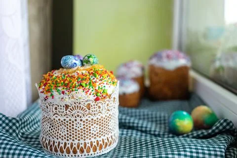 Traditional Easter cake with glace icing and Easter eggs on wooden background Stock Photos