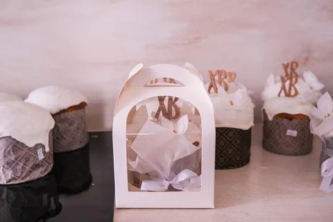 Traditional easter cake inside white gift box on kitchen table. Homemade kulich Stock Photos