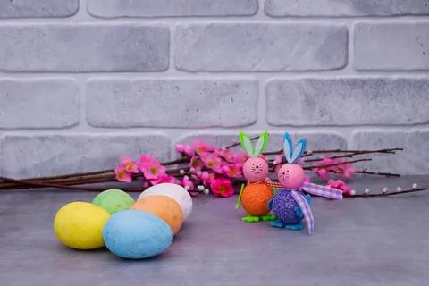 Traditional Easter cake, two decorative rabbits  and decorative flowers on ag Stock Photos