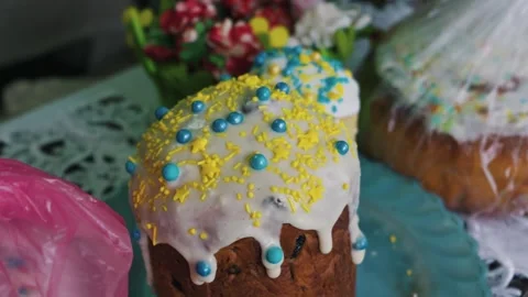 Traditional Easter Cake with White Icing and Blue and Yellow Sprinkles 스톡 동영상 334121443