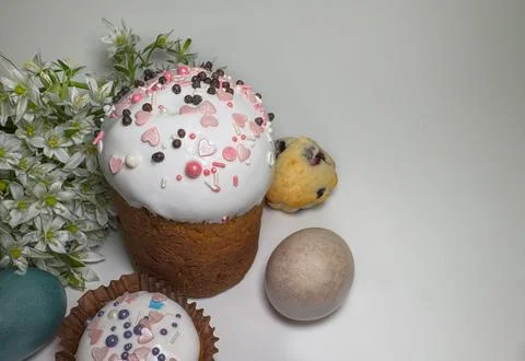 Traditional Easter cake with white icing and pink sprinkles Stock Photos