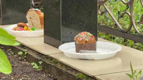 Traditional Easter Cakes And Sweets Sit On A Granite Grave Marker Stock Footage 334036908
