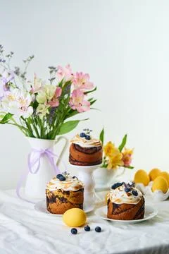Traditional Easter cakes on festive table decorated with fresh flowers and .. Stock Photos