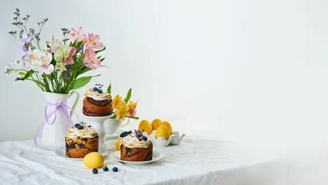 Traditional Easter cakes on festive table decorated with fresh flowers and .. Stock Photos
