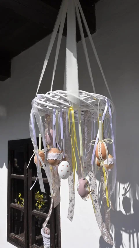 Traditional Easter egg mobile hanging on white wall. Stock Footage 332727539