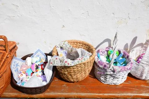 Traditional easter eggs, wicker baskets on rustic bench spring easter decoration Stock Photos