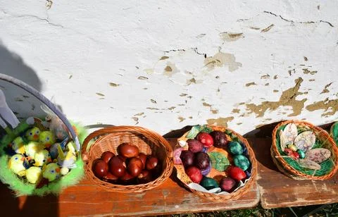 Traditional easter eggs, wicker baskets on rustic bench spring easter decoration Stock Photos