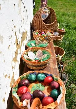 Traditional easter eggs, wicker baskets on rustic bench spring easter decoration Stock Photos