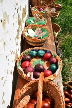 Traditional easter eggs, wicker baskets on rustic bench spring easter decoration Stock Photos