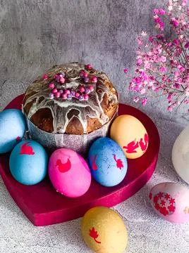 Traditional Easter food of Orthodox Easter cake and colored painted eggs, ver Stock Photos