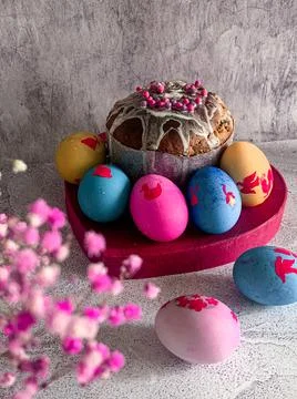 Traditional Easter food of Orthodox Easter cake and colored painted eggs, ver Stock Photos