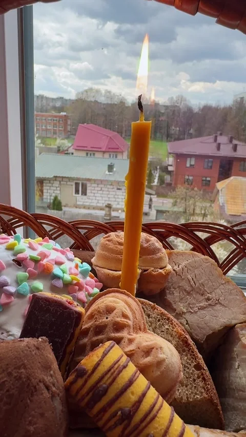 Traditional Easter food set inside woven basket with candle Stock Footage 334184604