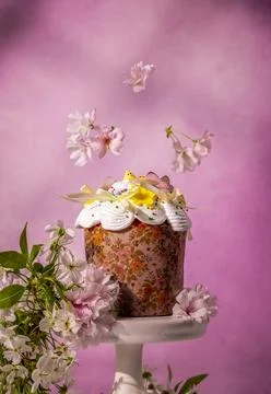 Traditional easter kulich with floral pattern and falling cherry blossoms Stock Photos