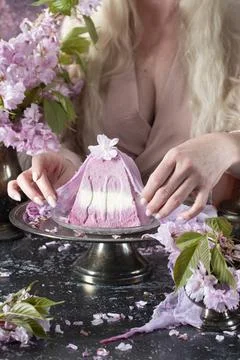 Traditional Easter Orthodox curd cake with sakura flowers, woman decorating food Stock Photos