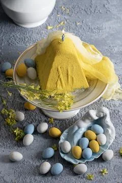Traditional Easter Orthodox curd cake with yellow flowers on a grey table Stock Photos