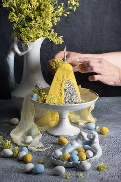 Traditional Easter Orthodox curd cake with yellow flowers on a grey table Stock Photos