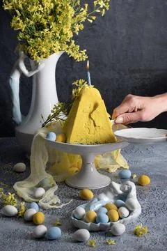 Traditional Easter Orthodox curd cake with yellow flowers on a grey table Stock Photos