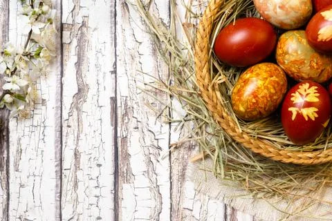 Traditional easter painted eggs in straw basket Stock Photos