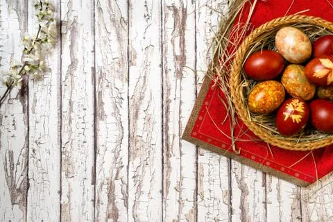 Traditional easter painted eggs in straw basket Stock Photos