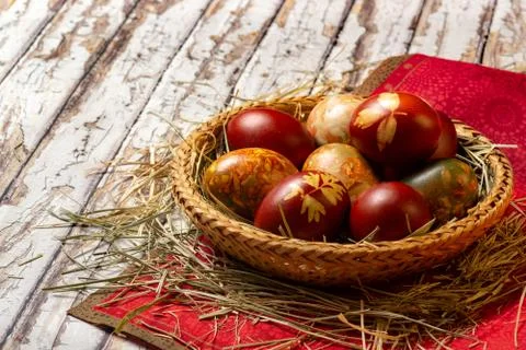 Traditional easter painted eggs in straw basket Stock Photos