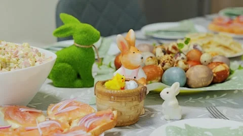 Traditional Easter Table With Dyed Eggs Fresh Salad Salmon Bites and Bunny Decor Stock Footage 344008334
