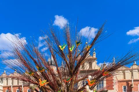 Traditional Easter tree of fluffy willow and wooden multi-colored birds in ce Stock Photos