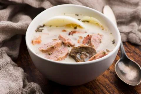 Traditional easter white borscht with eggs and sausage Stock Photos