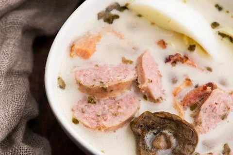 Traditional easter white borscht with eggs and sausage Stock Photos