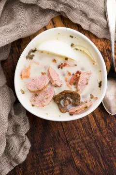 Traditional easter white borscht with eggs and sausage Stock Photos
