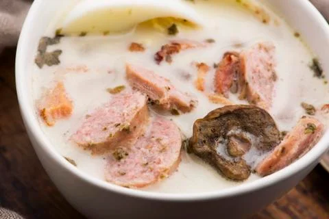 Traditional easter white borscht with eggs and sausage Stock Photos