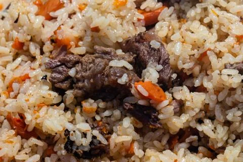 Traditional Eastern culinary dish - pilaf. Close-up view of Asian tasty food Stock Photos