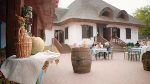 Traditional elements and resting people in a winery-restaurant in a village, Stock Footage 254603505