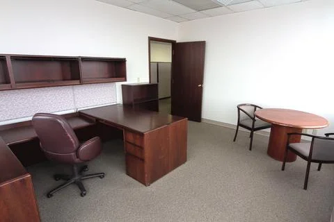 Traditional Empty Office Space with L-Shaped Desk and Meeting Table Stock Photos