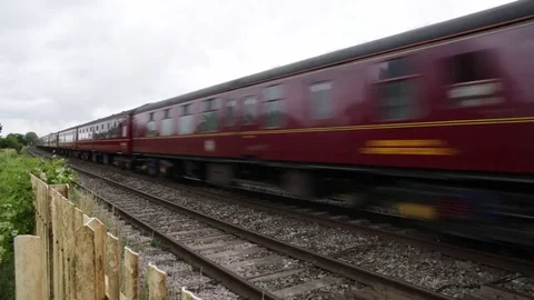 Traditional English steam engine on the railway - passing fast Stock Footage