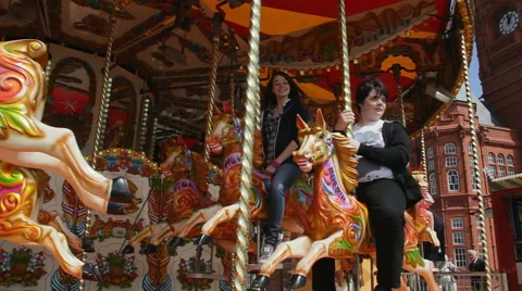 Traditional fairground carousel outside Silcocks Funland at Southport pier Stock Footage 44792689
