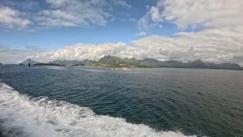 Traditional fish drying racks on coastal island with boat wake Lofoten Stock-Footage 344047577