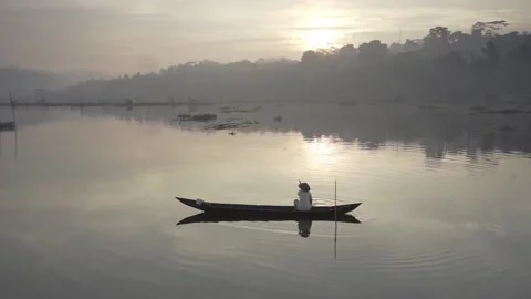 Traditional fisherman looking for freshwater fish at Rawa Pening lake Indonesia Stock Footage