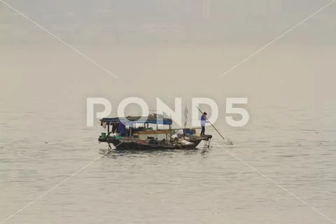 Traditional fishing boat in polluted Ha Long Bay Vietnam Stock Photos