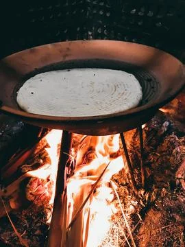 Traditional Flatbread Cooking Over Open Flame on Griddle Stock Photos