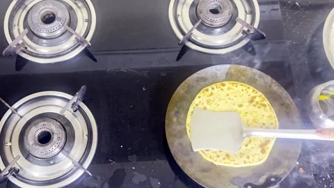 Traditional flatbread prepared beside modern stove surface Stock Footage 308613085