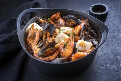 Traditional French seafood bouillabaisse with fish, king prawns and mussels i Stock Photos
