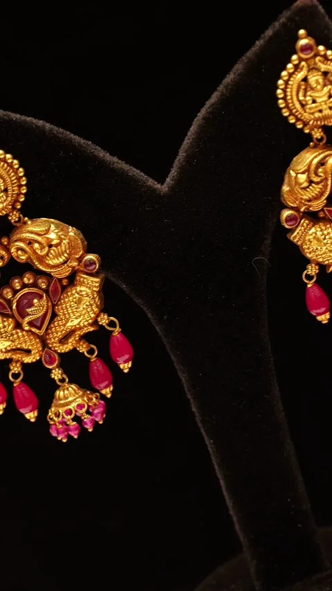 Traditional gold earrings with ruby stones rotating slowly in this beautiful ele Stock Footage 346248402