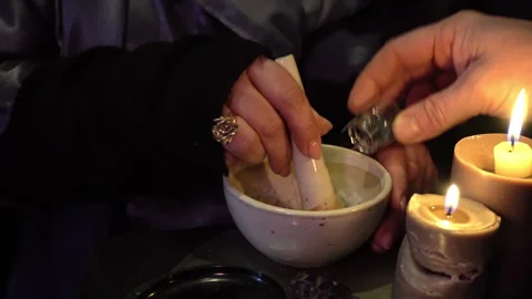 Traditional Grinding Process in Mortar by Candlelight 動画素材 346768084