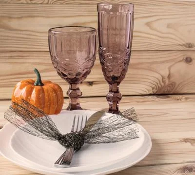 Traditional Halloween table setting in rustic style. Fork, knife, glasses and Stock Photos