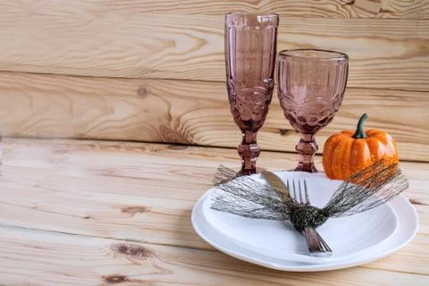 Traditional Halloween table setting in rustic style. Fork, knife, glasses, pl Stock Photos