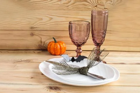 Traditional Halloween table setting in rustic style. Fork, knife, glasses, pl Stock Photos
