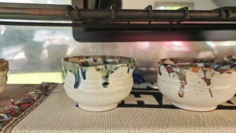 Traditional handmade ceramic chawan cups with dripping glaze effect. Видео 340506820