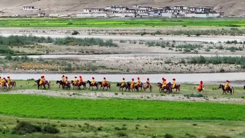 Traditional Horseback Riders Procession Through Rural Landscape Tibet China 動画素材 346737918
