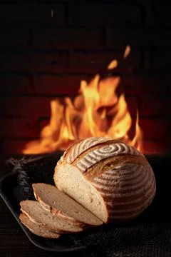 Traditional house bread on the table in front of a red bricks Stock Photos